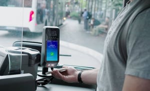 Passenger validates a ticket on a smartphone at the validator